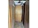 Hallway with wood paneling, light fixture, and door at 1405 Mote Rd, Covington, GA 30016