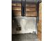 Kitchen with damaged walls, missing appliances, cabinets, and plywood over the window at 1405 Mote Rd, Covington, GA 30016