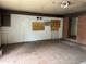 Unfinished living room with a brick accent wall, paint swatches, and unfinished ceilings at 1405 Mote Rd, Covington, GA 30016