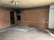 Unfinished living room with a brick accent wall, paint swatches, and unfinished ceilings at 1405 Mote Rd, Covington, GA 30016