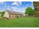 Spacious backyard featuring a well-maintained lawn, complemented by the home's exterior and ample natural light at 1815 Montcliff Dr, Cumming, GA 30041