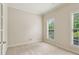 Bright bedroom with natural light streaming through two windows with view of mature trees at 1815 Montcliff Dr, Cumming, GA 30041