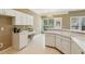 Eat-in kitchen with white cabinetry and plenty of natural light from the large windows at 1815 Montcliff Dr, Cumming, GA 30041