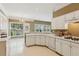 Bright kitchen with white cabinets, stainless appliances, and access to the backyard at 1815 Montcliff Dr, Cumming, GA 30041