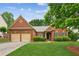 Charming brick home featuring a manicured front lawn and a two-car garage at 1815 Montcliff Dr, Cumming, GA 30041