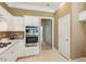Updated kitchen featuring stainless appliances and white cabinets with ample storage at 1815 Montcliff Dr, Cumming, GA 30041