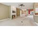 Spacious living room features fireplace, neutral carpet, and connects to other rooms at 1815 Montcliff Dr, Cumming, GA 30041