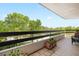Outdoor balcony with tile flooring and black metal railings, offering views of lush greenery and blue sky at 2660 Peachtree Rd # 7F, Atlanta, GA 30305