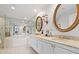 Well-lit bathroom with dual sinks, vanity, tub and an oversized mirror at 2660 Peachtree Rd # 7F, Atlanta, GA 30305