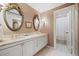 Elegant bathroom with marble countertops, dual sinks, and ornate mirrors at 2660 Peachtree Rd # 7F, Atlanta, GA 30305