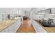 Bright kitchen with white cabinetry, granite counters, stainless appliances, and a view into the dining area at 2660 Peachtree Rd # 7F, Atlanta, GA 30305