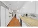 Galley kitchen featuring white cabinets, granite countertops, and modern appliances at 2660 Peachtree Rd # 7F, Atlanta, GA 30305