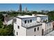 A unique aerial view of new construction homes with rooftop decks against the city skyline at 420-D Parkway Ne Dr, Atlanta, GA 30308