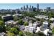 Aerial view shows homes with their roofs and surrounding greenery, set against a backdrop of the city skyline at 420-D Parkway Ne Dr, Atlanta, GA 30308