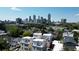 Rooftop view of several townhomes nestled in a lush urban setting, with the city skyline visible in the distance at 420-D Parkway Ne Dr, Atlanta, GA 30308