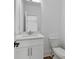 Clean bathroom featuring marble countertop, white cabinets and a toilet at 420-D Parkway Ne Dr, Atlanta, GA 30308