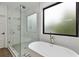 Spa-like bathroom featuring a standalone tub and glass enclosed shower at 420-D Parkway Ne Dr, Atlanta, GA 30308