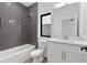 Modern bathroom with sleek gray subway tile, modern fixtures, and a combined tub and shower at 420-D Parkway Ne Dr, Atlanta, GA 30308