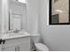 Powder room with modern vanity, white cabinets, quartz counters, and stylish fixtures at 420-D Parkway Ne Dr, Atlanta, GA 30308