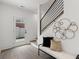 Modern foyer with a view of the staircase, stylish bench and art decoration at 420-D Parkway Ne Dr, Atlanta, GA 30308