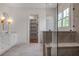 Beautiful bathroom featuring a shower and vanity with lots of natural light and a walk-in closet at 50 Maple St, Roswell, GA 30075