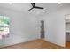 Bright bedroom with hardwood floors, a ceiling fan, natural light, and a doorway leading to a closet at 50 Maple St, Roswell, GA 30075