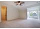Bedroom featuring carpeted floors, modern ceiling fan, and natural light at 50 Maple St, Roswell, GA 30075