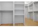Walk-in closet boasts built-in shelving and ample storage space, offering a functional and organized design at 50 Maple St, Roswell, GA 30075