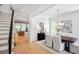 Bright dining room with modern chandelier, white chairs, and an adjacent staircase at 50 Maple St, Roswell, GA 30075