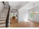 Bright entryway featuring hardwood floors, white trim, staircase with iron railing, and natural light at 50 Maple St, Roswell, GA 30075