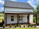 Charming home exterior featuring a covered porch and landscaped front yard at 50 Maple St, Roswell, GA 30075