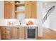 Kitchen bar area with wooden cabinets, built in wine fridge, and modern design at 50 Maple St, Roswell, GA 30075