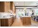 Well-lit kitchen featuring wood cabinets, a center island, and stainless steel appliances at 50 Maple St, Roswell, GA 30075