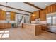Bright kitchen with wood cabinets, beams, island, and stainless steel appliances at 50 Maple St, Roswell, GA 30075