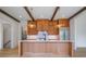 Open kitchen with wood cabinets, center island with countertop, and stainless steel appliances at 50 Maple St, Roswell, GA 30075