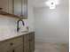 Laundry room with modern cabinets, marble countertops, and a sleek faucet at 50 Maple St, Roswell, GA 30075