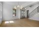 Open-concept living space with hardwood floors, large windows, and modern lighting fixtures at 50 Maple St, Roswell, GA 30075