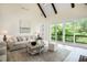 Bright living room features large sliding doors to deck, light floors, and vaulted ceilings at 50 Maple St, Roswell, GA 30075