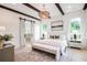 Bright main bedroom featuring hardwood floors, decorative lighting, and ensuite bathroom at 50 Maple St, Roswell, GA 30075