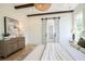 Bright main bedroom features barn door to en suite and light hardwood flooring at 50 Maple St, Roswell, GA 30075