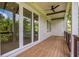 Covered porch with ceiling fan provides a relaxing outdoor living space overlooking a wooded landscape at 50 Maple St, Roswell, GA 30075