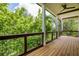Spacious porch showcasing wood floors, a wood railing, and views of the lush greenery at 50 Maple St, Roswell, GA 30075