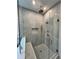 Modern bathroom features a spacious walk-in shower with a tiled bench and contemporary fixtures at 50 Maple St, Roswell, GA 30075