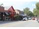 Charming street view with brick buildings and bustling outdoor seating areas under a sunny sky at 50 Maple St, Roswell, GA 30075