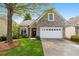 Charming home featuring a stone facade, a two-car garage, and a lush green lawn at 832 Chalet Hls, Mcdonough, GA 30253