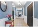 Inviting hallway featuring decorative wall trim, tile floors, and elegant lighting fixtures at 832 Chalet Hls, Mcdonough, GA 30253