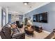 Spacious living room with comfortable leather seating and a large-screen television at 832 Chalet Hls, Mcdonough, GA 30253