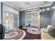Bright sitting area with large windows, stylish rug, and access to the outdoors at 832 Chalet Hls, Mcdonough, GA 30253