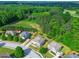 Aerial view of a house with a large lot surrounded by lush greenery in a neighborhood at 105 Tanners Ct, Covington, GA 30016