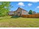 Large, fenced backyard with a lush green lawn, offering privacy and space for outdoor activities at 105 Tanners Ct, Covington, GA 30016